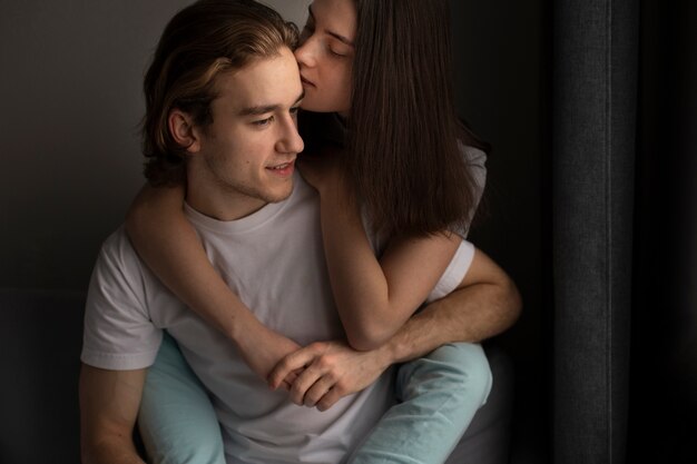 Girlfriend hugging man while holding hands