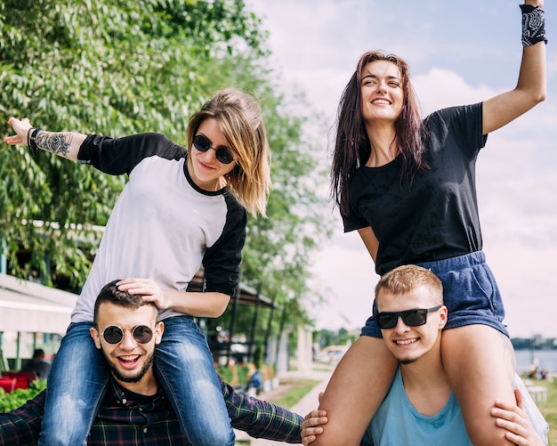 Girlfriends making fun with boyfriends at outdoors