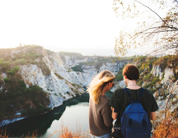 Girlfriends standing in rear view on top of the mountain