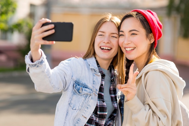 Girlfriends taking selfie