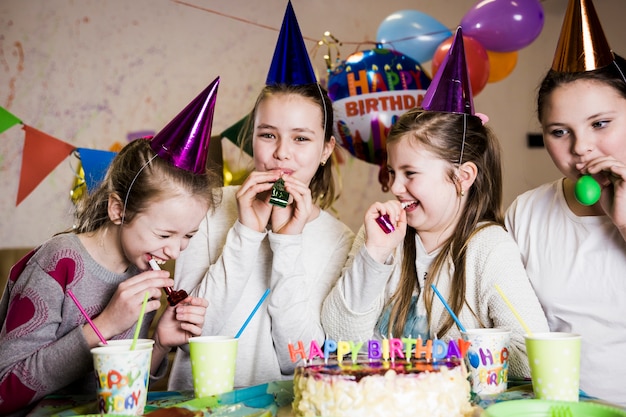 Free Photo girls blowing party horns