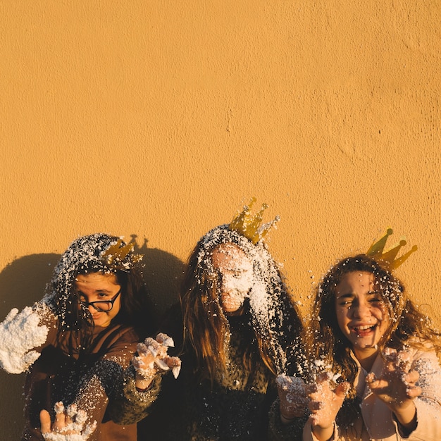 Girls covered with artificial snow