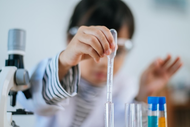 Girls doing science experiments in the lab. Selective focus.