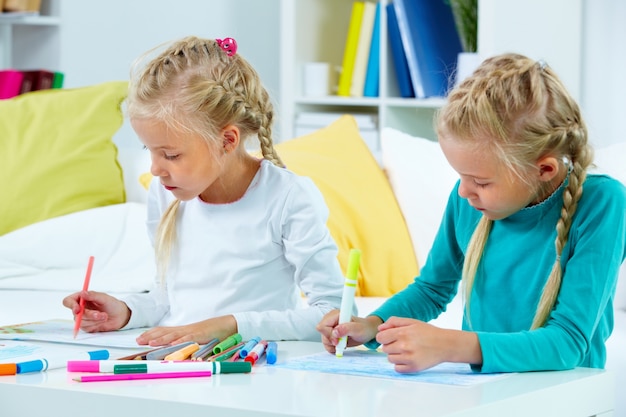 Girls drawing in their notebooks