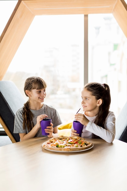 Free Photo girls eating pizza