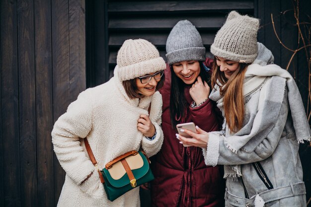 Girls friends meeting together at winter time outside the street