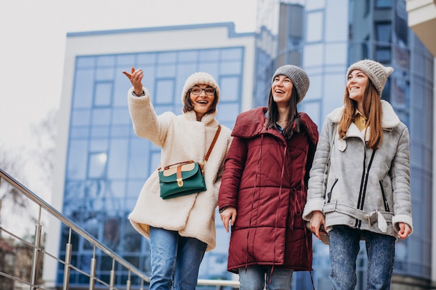 Girls friends meeting together at winter time outside the street