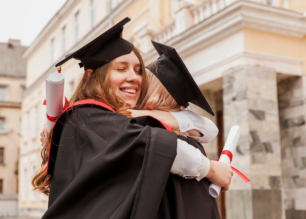 Free photo girls hugging at graduation