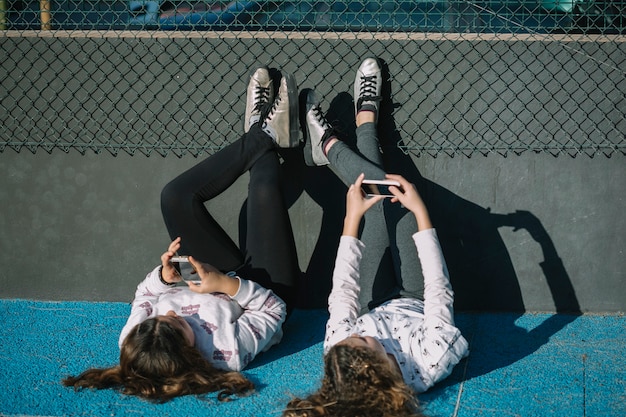 Girls lying together on rooftop