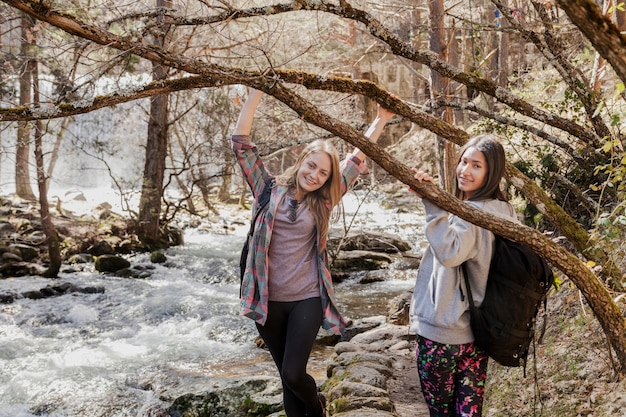 Free photo girls playing with some branches in the forest