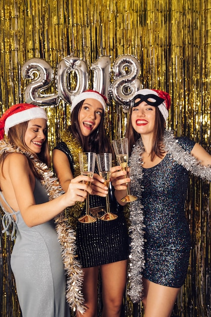 Girls posing with champagne on new year party