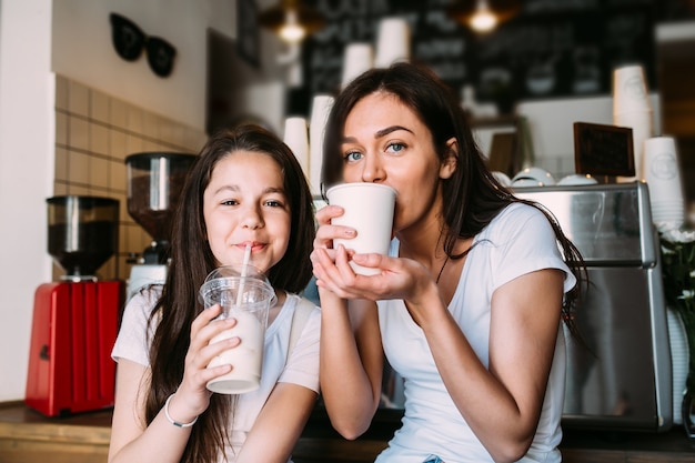 Girls sitting in cafeteria drinking