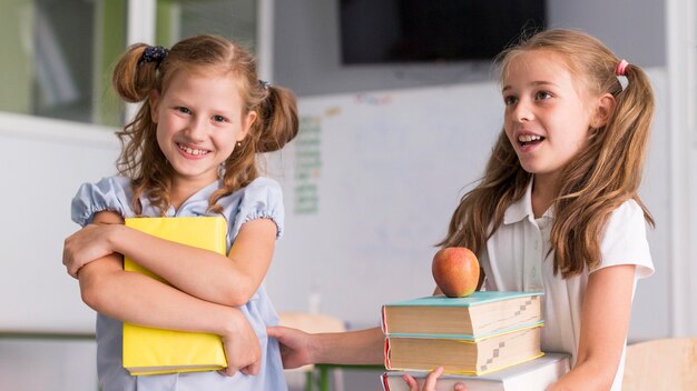 Girls smiling while holding their books