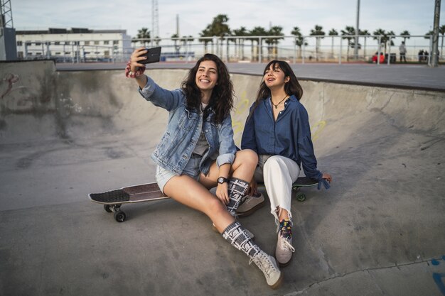 Girls taking a photo of themselves in a skate park