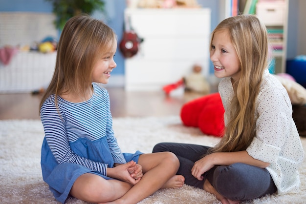 Girls talking to each other in the living room