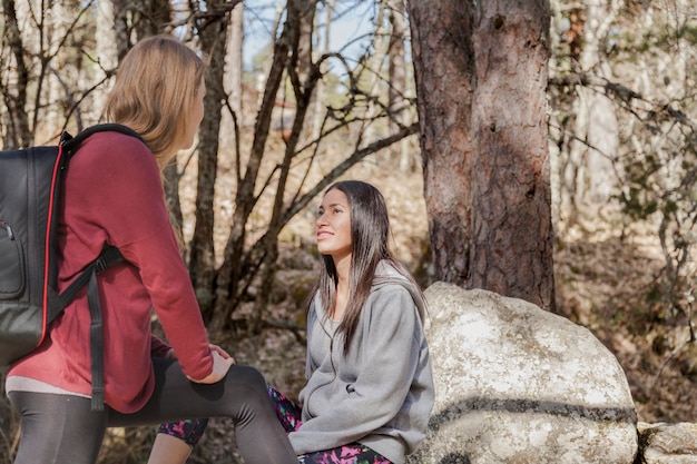 Girls talking in the forest