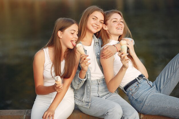 Girls walking in a spring city and hold ice cream in hand