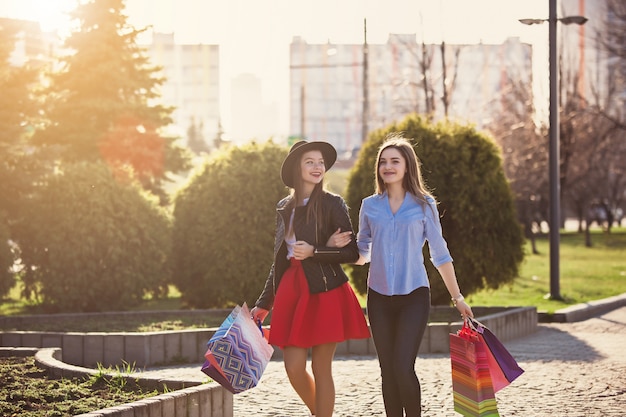 Free photo girls walking with shopping on city streets