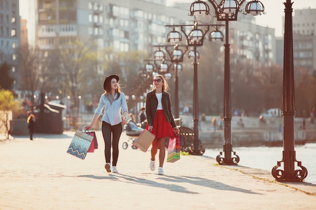 Free photo girls walking with shopping on city streets