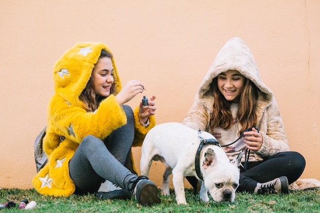 Free photo girls with dog on grass