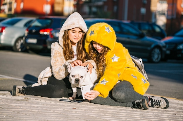 Girls with dog on street