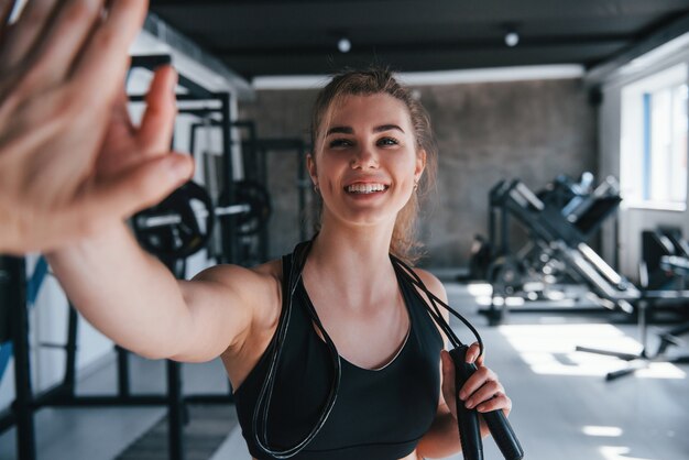 Giving high-five.  gorgeous blonde woman in the gym at her weekend time