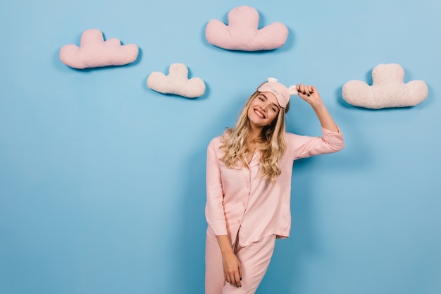 Free Photo glad female model in pink pajama expressing happiness