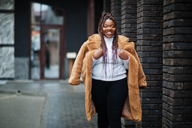 Glamorous african american woman in warm fur coat pose at street