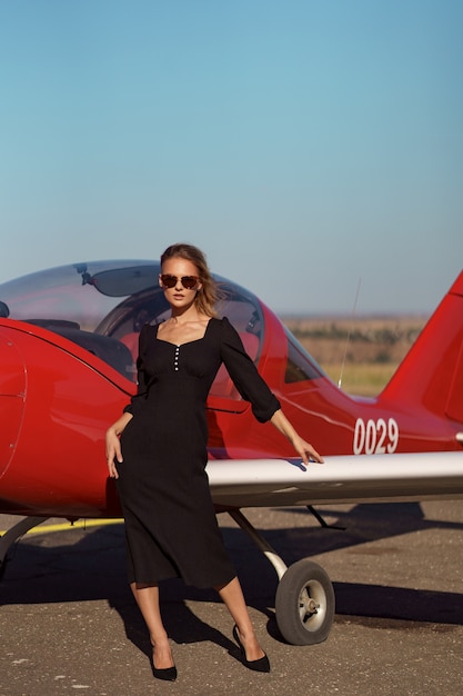 Free Photo glamorous woman posing on plane