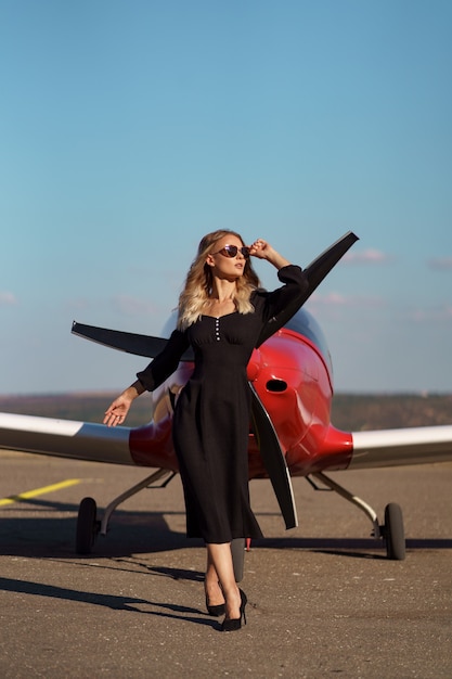 Glamorous woman posing on plane