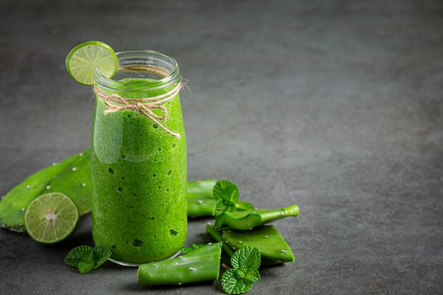 glass of aloe vera  juice put on dark floor