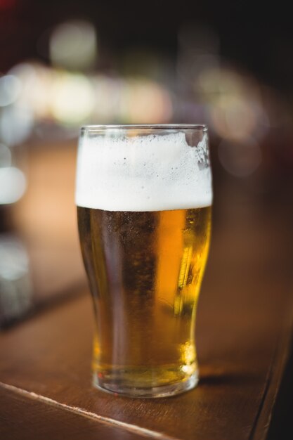 Glass of beer in bar counter