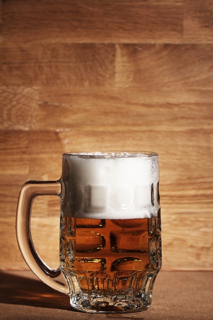 Free photo glass of beer over wooden surface