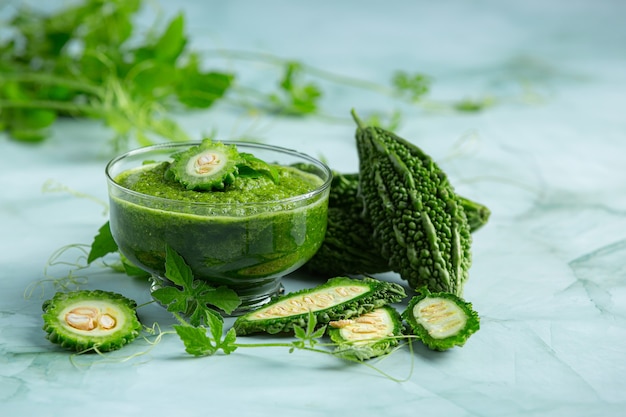 a glass of bitter gourd smoothie with shopped bitter gourd