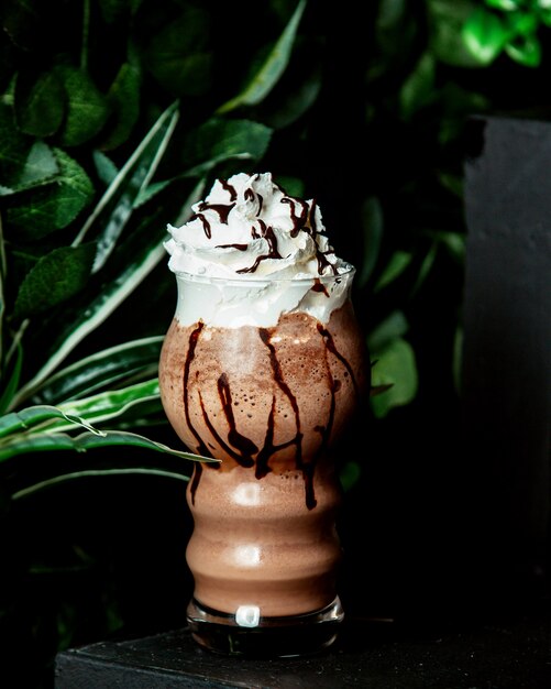 Free Photo a glass of cacao drink with chocolate syrup and whipped cream