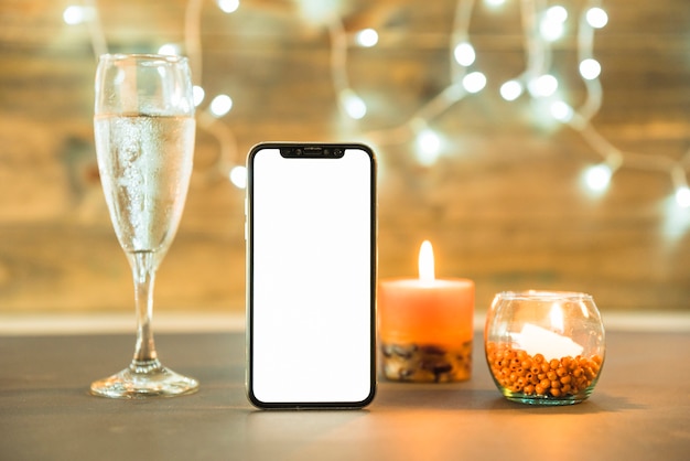 Free photo glass of champagne with candle on table