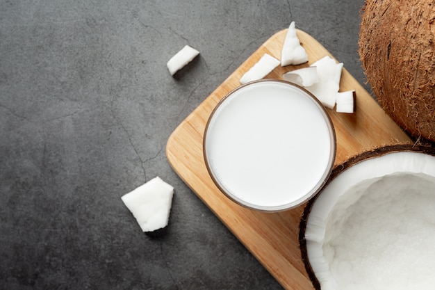 glass of coconut milk put on wooden cutting board