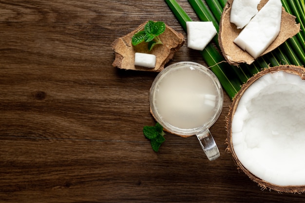 glass of coconut water put on dark wooden background