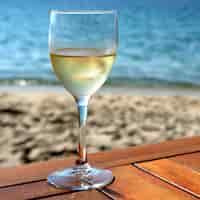 Free photo glass cold white wine mediterranean beach table square