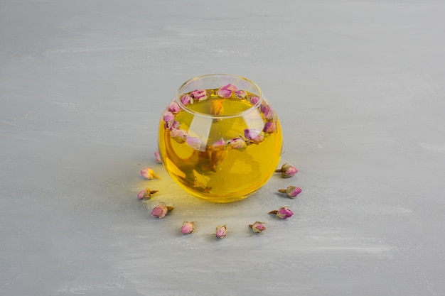 Glass cup of tea on grey table