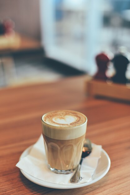 Glass cup with coffee and a teaspoon