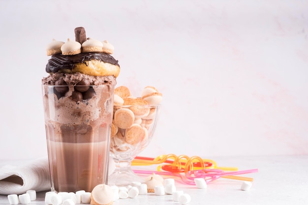 Glass of dessert with donut and marshmallows