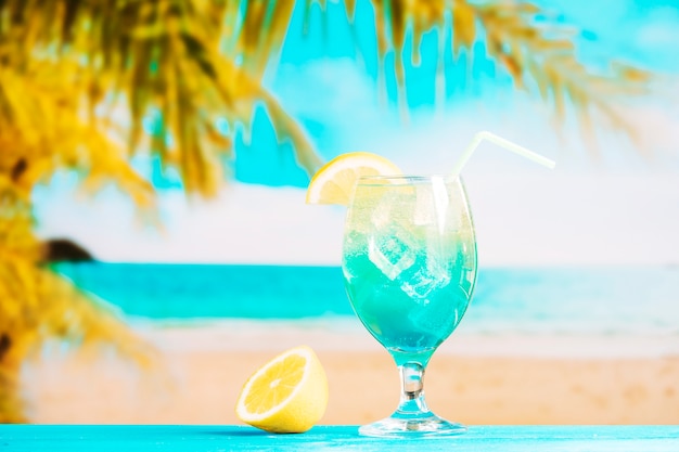 Free photo glass of fresh blue drink with straw and sliced lime