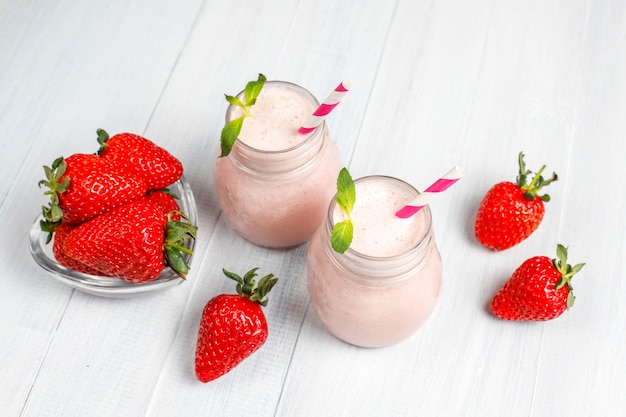 Glass of fresh strawberry milkshake, smoothie and fresh strawberries,healthy food and drink concept.