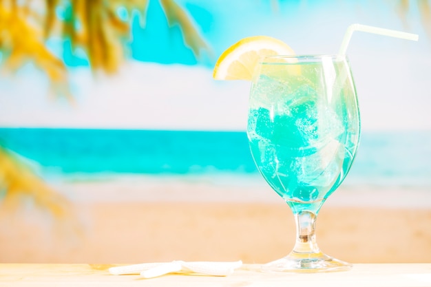 Glass of frozen blue drink with straw