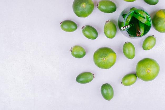 Free Photo a glass of green drink with feijoa and mandarines