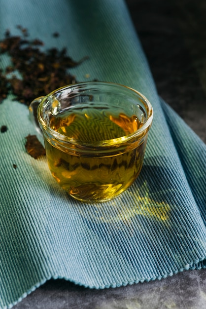 Glass herbal tea on blue napkin