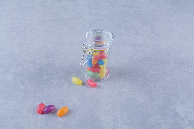 Free photo a glass jar full of colorful bean candies