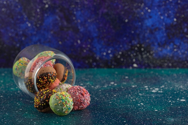 Free Photo a glass jar full of small colorful doughnuts .