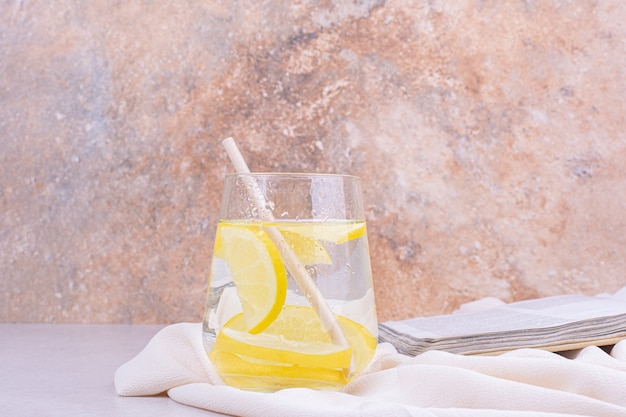 A glass of juice with lemon slices